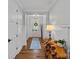 Bright foyer with hardwood floors, white trim, and stylish wooden table at 7730 Burning Ridge Dr, Stanley, NC 28164