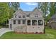 Charming two-story brick home with landscaped front yard and covered front porch at 7730 Burning Ridge Dr, Stanley, NC 28164