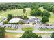 Aerial view featuring a community clubhouse and pool alongside a well-kept golf course at 7730 Burning Ridge Dr, Stanley, NC 28164