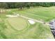 Aerial view of a meticulously maintained golf course with sand traps and lush green fairways at 7730 Burning Ridge Dr, Stanley, NC 28164