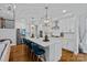 Bright, modern kitchen with a large center island, white cabinets, and stainless steel appliances at 7730 Burning Ridge Dr, Stanley, NC 28164
