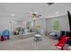 Bright playroom with a large sofa, plenty of toys and a television at 7730 Burning Ridge Dr, Stanley, NC 28164