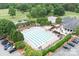 Aerial shot of an immaculate swimming pool area with lounge chairs and manicured hedges at 7730 Burning Ridge Dr, Stanley, NC 28164