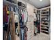Custom walk-in closet with ample storage, built-in shelving, hanging rods, and a full-length mirror at 7730 Burning Ridge Dr, Stanley, NC 28164