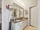 Bright bathroom featuring double sinks, granite counters, decorative mirrors, and modern fixtures at 7923 Shiny Meadow Ln, Charlotte, NC 28215
