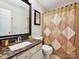 Bathroom featuring a vanity sink with granite countertops, decorative shower curtain, and a tiled floor at 7923 Shiny Meadow Ln, Charlotte, NC 28215