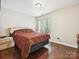Bedroom featuring hardwood floors, natural light from a window, and neutral color walls at 7923 Shiny Meadow Ln, Charlotte, NC 28215