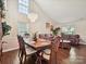 Open-concept dining area with lots of space, chandelier, and hardwood flooring at 7923 Shiny Meadow Ln, Charlotte, NC 28215
