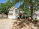 Charming two-story home with a two-car garage, inviting front porch, and well-manicured landscaping at 7923 Shiny Meadow Ln, Charlotte, NC 28215