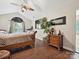 Comfortable main bedroom features hardwood floors and plenty of natural light at 7923 Shiny Meadow Ln, Charlotte, NC 28215