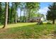 Expansive backyard with lush greenery and play area, perfect for outdoor enjoyment at 808 Sharon Dr, Waxhaw, NC 28173