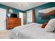 Bedroom boasts a light bed, light floors, teal walls, and wood furnishings at 808 Sharon Dr, Waxhaw, NC 28173