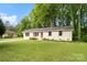 Inviting single-story home with a lush green lawn and mature trees, offering great curb appeal at 808 Sharon Dr, Waxhaw, NC 28173