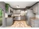 Modern kitchen featuring stainless steel appliances, gray cabinets, and granite countertops at 808 Sharon Dr, Waxhaw, NC 28173