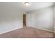 Neutral bedroom featuring carpet, closet, and an open doorway at 9109 Loch Glen Way, Charlotte, NC 28278