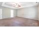 Spacious carpeted bedroom with tray ceiling and natural light at 9109 Loch Glen Way, Charlotte, NC 28278