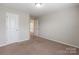 Bedroom featuring carpet, a window, and two doors for accessibility at 9109 Loch Glen Way, Charlotte, NC 28278