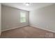 Neutral bedroom with carpeted floors, a window providing natural light, and ample space at 9109 Loch Glen Way, Charlotte, NC 28278