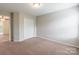 Bedroom with carpet flooring, closet, and doorway leading to another room at 9109 Loch Glen Way, Charlotte, NC 28278