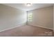 Cozy bedroom with carpeted floors and a window offering natural light at 9109 Loch Glen Way, Charlotte, NC 28278