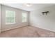 Bright bedroom with two windows and carpeted flooring, offering a comfortable space at 9109 Loch Glen Way, Charlotte, NC 28278