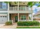 Inviting two-story home featuring a welcoming front porch with decorative stone accents and manicured bushes at 9109 Loch Glen Way, Charlotte, NC 28278