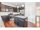 Well-equipped kitchen featuring stainless steel appliances, granite countertops, and a functional center island at 9109 Loch Glen Way, Charlotte, NC 28278