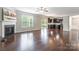 Open-concept living space with hardwood floors, fireplace, and seamlessly connected to the kitchen area at 9109 Loch Glen Way, Charlotte, NC 28278