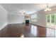 Spacious living room featuring a fireplace, hardwood floors, and access to a patio, perfect for entertaining at 9109 Loch Glen Way, Charlotte, NC 28278