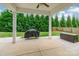 Relaxing outdoor patio area with ceiling fan and grill, perfect for entertaining and enjoying the outdoors at 9109 Loch Glen Way, Charlotte, NC 28278