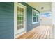 Covered porch with wood decking and blue siding, offering a cozy outdoor space at 9109 Loch Glen Way, Charlotte, NC 28278
