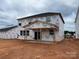 New construction home featuring Tyvek home wrap, visible framing, and a covered porch at 918 Windy Oak Ct, Indian Trail, NC 28079