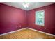 Vacant bedroom with wooden floors and a bright window at 9801 Kent Village Dr, Charlotte, NC 28269