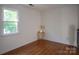 Vacant bedroom with laminate flooring and a bright window at 9801 Kent Village Dr, Charlotte, NC 28269