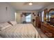 Bedroom featuring a patterned bedspread and natural lighting at 9801 Kent Village Dr, Charlotte, NC 28269