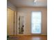Minimalist bedroom with natural light and hardwood laminate floors at 9801 Kent Village Dr, Charlotte, NC 28269