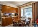 Warm dining area with wood table adjacent to the cozy kitchen at 9801 Kent Village Dr, Charlotte, NC 28269