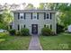 Traditional two-story house featuring black shutters and a welcoming front entrance at 9801 Kent Village Dr, Charlotte, NC 28269