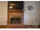 Close up showcasing a traditional brick fireplace with wooden mantel at 9801 Kent Village Dr, Charlotte, NC 28269
