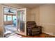 A comfortable living space featuring a door leading to the outdoor sunroom at 9801 Kent Village Dr, Charlotte, NC 28269