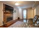 Inviting living room featuring a cozy brick fireplace and modern hard wood floors at 9801 Kent Village Dr, Charlotte, NC 28269