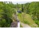 An aerial view shows the home with a long driveway through a wooded lot at 1009 Catawba Valley Se Blvd, Hickory, NC 28602