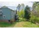 This home features a spacious backyard with mature trees, a gentle stream, and a screened-in porch at 1009 Catawba Valley Se Blvd, Hickory, NC 28602