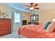 Cozy bedroom featuring carpet floors, ceiling fan, and a dresser with a decorative mirror at 1009 Catawba Valley Se Blvd, Hickory, NC 28602