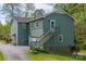 A charming home features a side-entry garage, a well-kept lawn, and a stairway to a side door at 1009 Catawba Valley Se Blvd, Hickory, NC 28602
