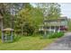 Set among lush greenery, this two-story home includes a gazebo, inviting porch, and lovely landscaping at 1009 Catawba Valley Se Blvd, Hickory, NC 28602