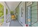 Inviting front porch featuring comfortable seating, decor, and a view of the surrounding greenery at 1009 Catawba Valley Se Blvd, Hickory, NC 28602