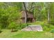 A two story outbuilding sits nestled amongst mature trees and verdant landscaping at 1009 Catawba Valley Se Blvd, Hickory, NC 28602