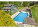 An aerial view shows a large in-ground pool, a gazebo, and an outdoor dining area in a fenced backyard at 1009 Catawba Valley Se Blvd, Hickory, NC 28602