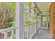 Relaxing porch view with decorative items and lush greenery beyond the railings at 1009 Catawba Valley Se Blvd, Hickory, NC 28602